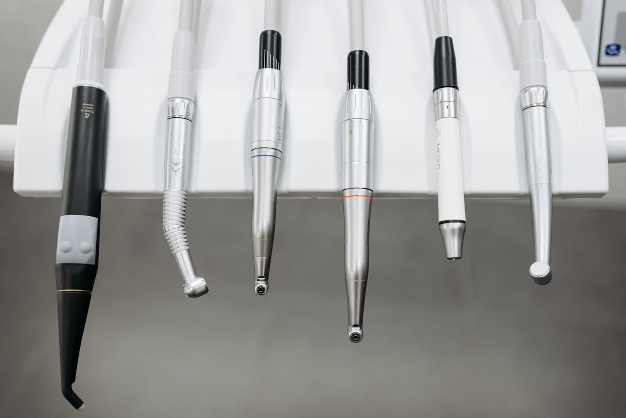 our-experience Close-up view of dental instruments organized in a holder, ready for use.